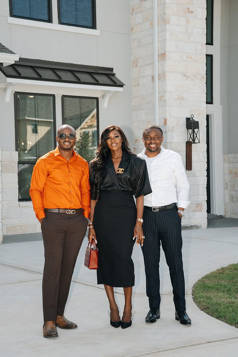 Henry with his clients in front of their new home