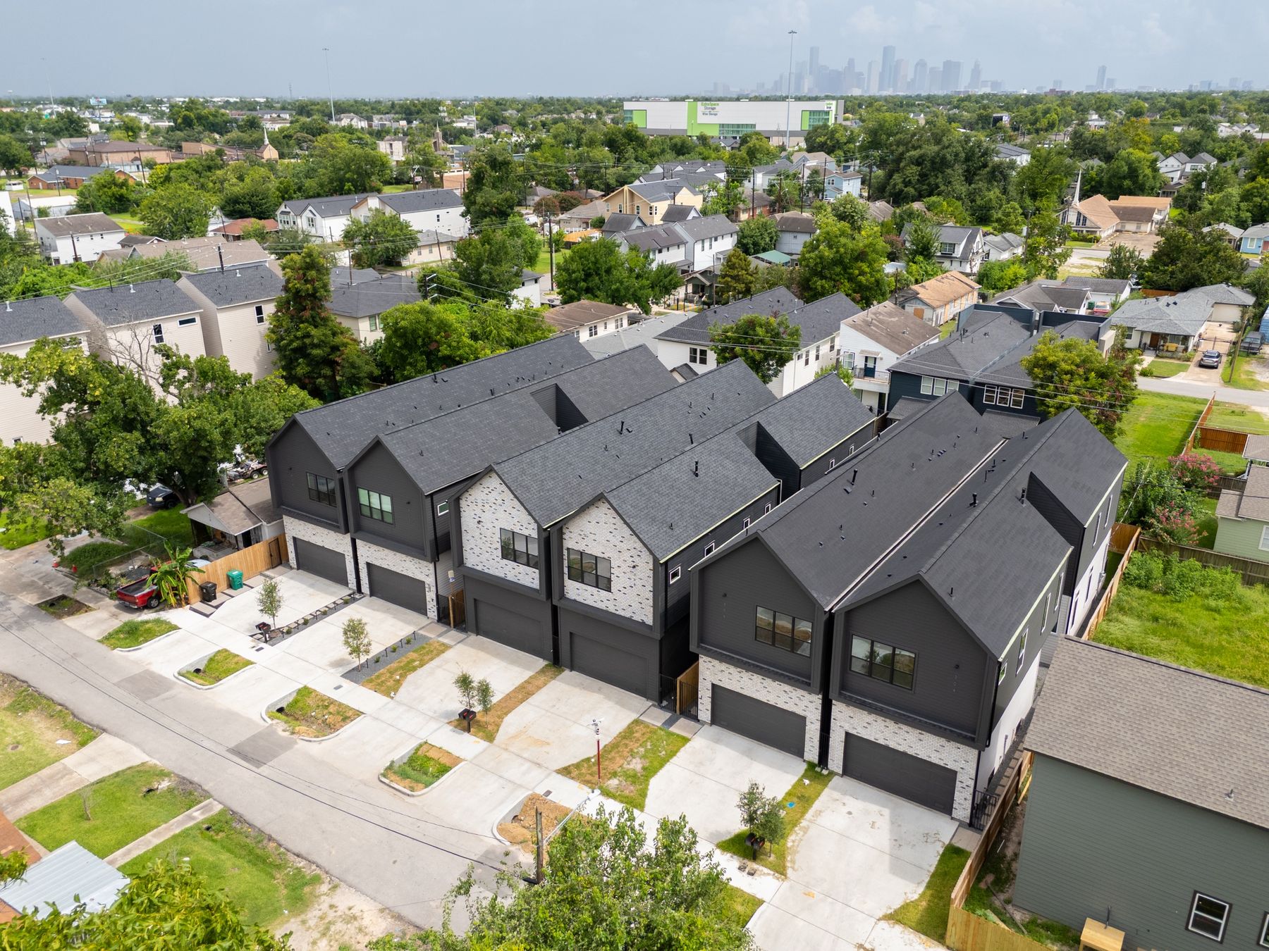 Aerial view of the six Independence Heights homes with downtown Houston beyond